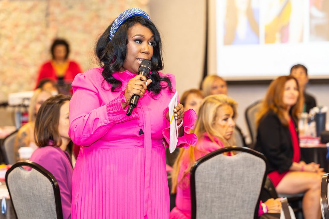 An attendee speaking into a microphone from the audience