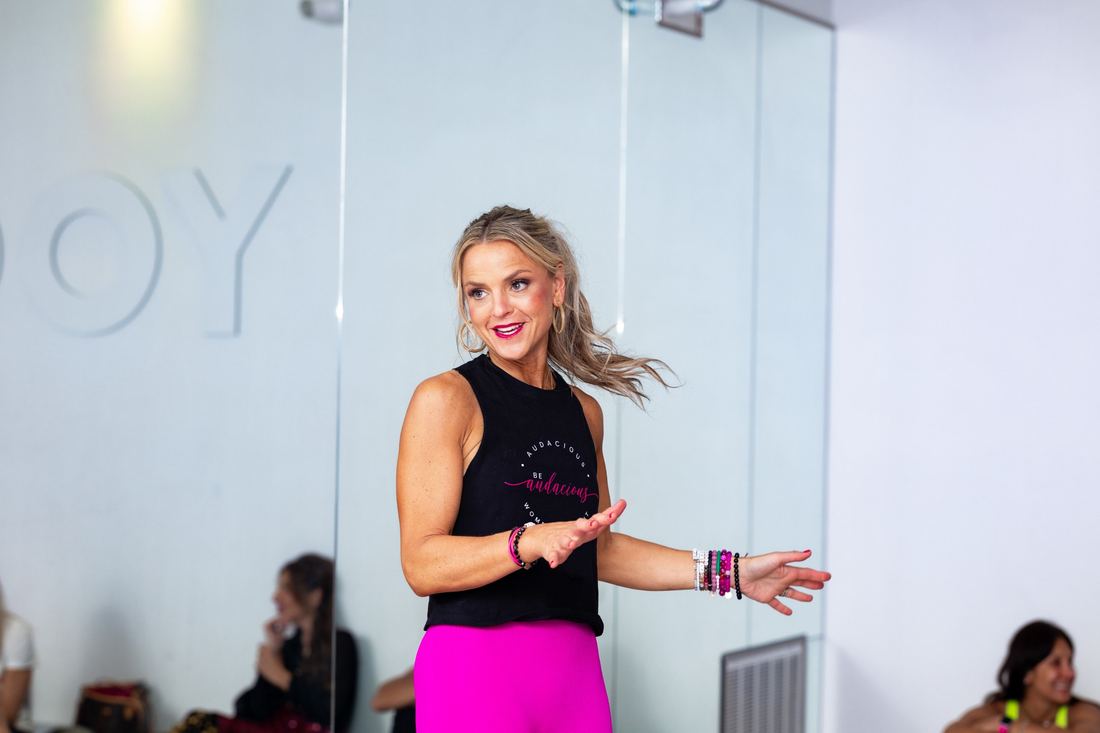 Erika Rothenberger leading the room in an Audacious Women's Summit tank