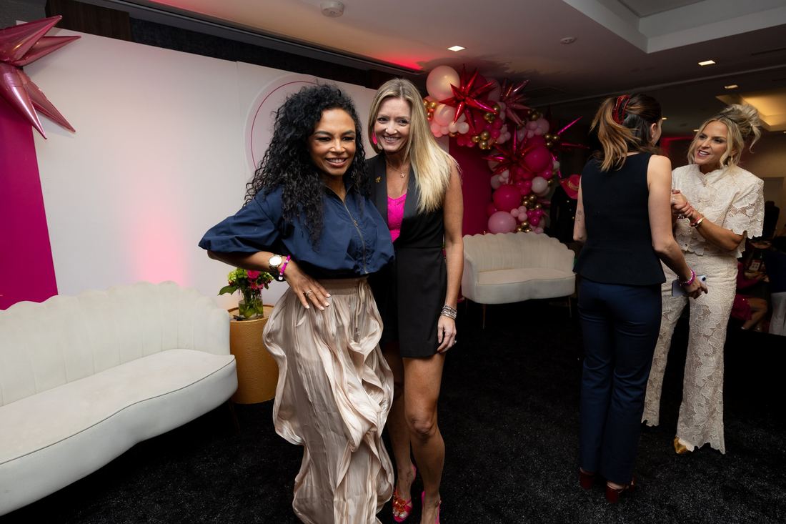 Two women posing at the Summit celebration