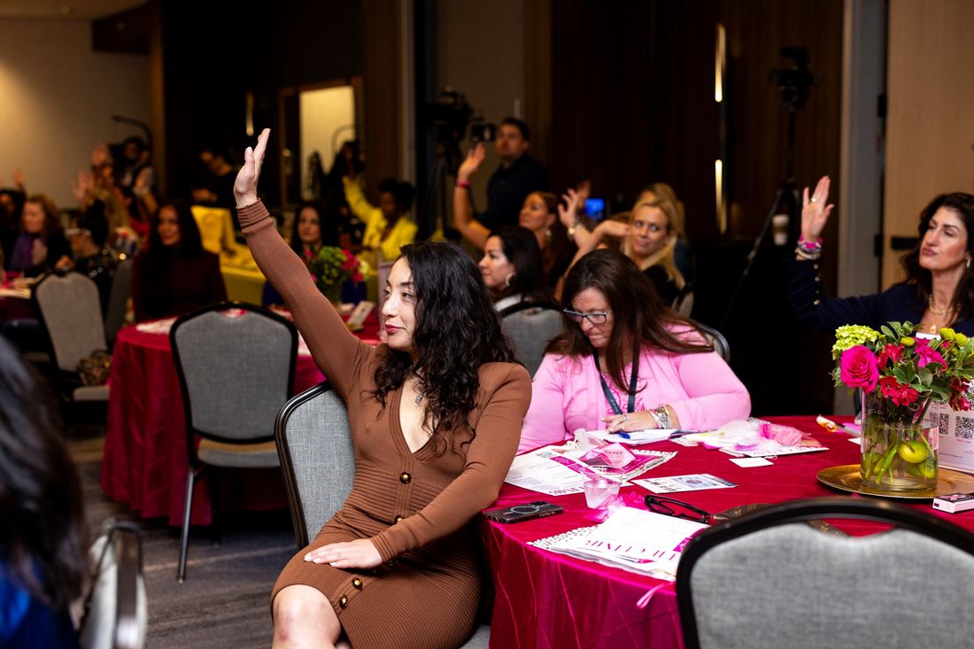 An attendee raising her hand during a session