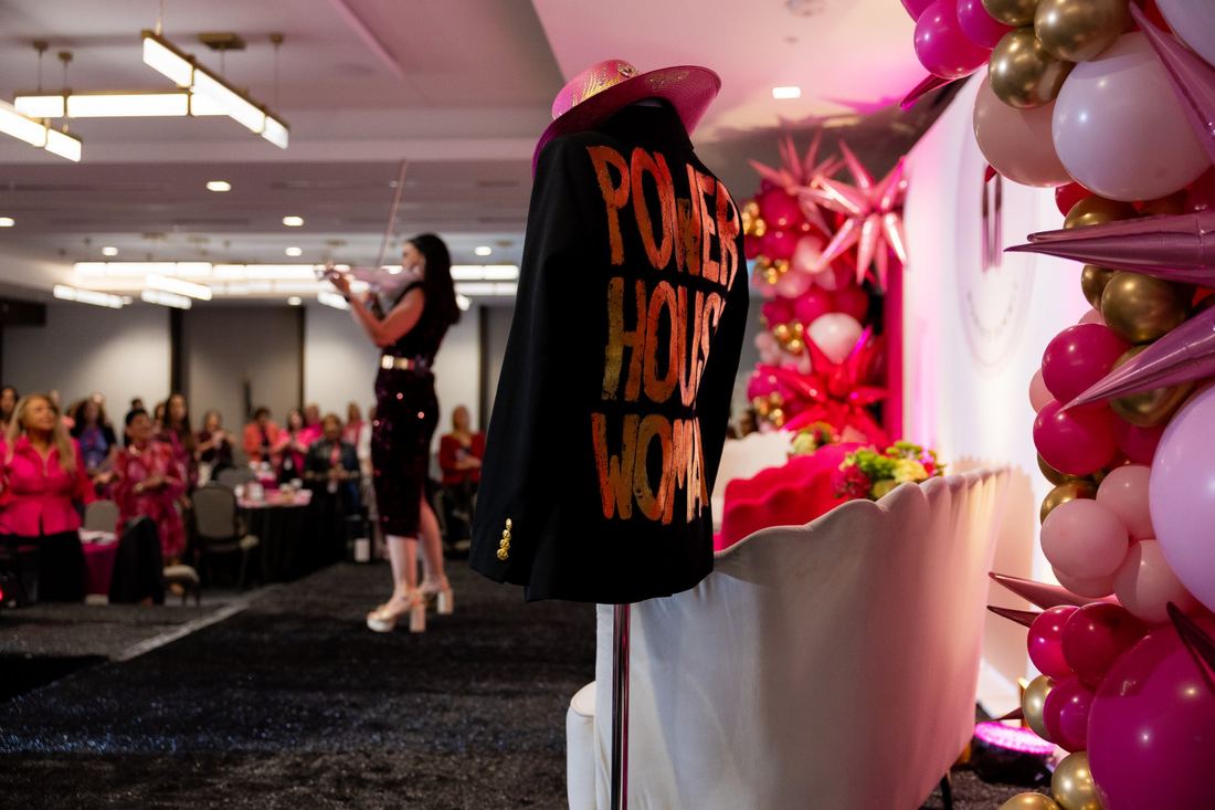 A violinist performing beside the Power House Woman jacket