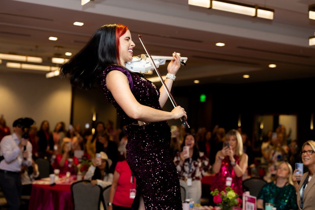 A violinist in sequins performing for the room